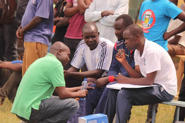 MMUST Fc technical bench team led by lead coach Charles Omwalo (in stripped white T-shirt) during the match played verses Tranzfoc FC at Kakamega Approved School on Saturday 26th October 2019 where MMUST FC won 2-1