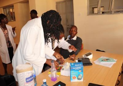 A section of healthcare professionals testing one of the University staff during the drive